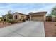 Spacious home with a three-car garage and a well-lit driveway at 9295 W Quail Track Dr, Peoria, AZ 85383