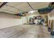 Spacious garage with ample storage, including overhead racks and room for a workout area at 9295 W Quail Track Dr, Peoria, AZ 85383