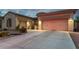 Spacious home with a three-car garage and a well-lit driveway at 9295 W Quail Track Dr, Peoria, AZ 85383