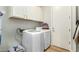 Laundry area with a washer and dryer with white cabinets at 9295 W Quail Track Dr, Peoria, AZ 85383