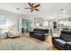 Comfortable living room showcasing hardwood floors and sliding glass doors providing lots of light to the main living area at 9295 W Quail Track Dr, Peoria, AZ 85383