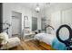 Well-lit room featuring wood-look floors, neutral paint, and a chandelier at 9295 W Quail Track Dr, Peoria, AZ 85383