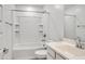 Clean white bathroom featuring a shower-tub combo and a vanity sink at 9520 W Trumbull Rd, Tolleson, AZ 85353