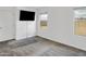 Neutral-toned carpeted bedroom offers two windows and a door at 9520 W Trumbull Rd, Tolleson, AZ 85353