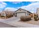 Attractive one-story home boasting desert landscaping and a spacious driveway leading to a garage at 9520 W Trumbull Rd, Tolleson, AZ 85353