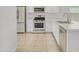 Modern kitchen showcasing white cabinetry, stainless steel appliances, and ample counter space at 9520 W Trumbull Rd, Tolleson, AZ 85353