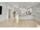 Bright open-concept living room and kitchen boasts tile flooring and stainless steel appliances at 9520 W Trumbull Rd, Tolleson, AZ 85353