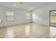 Light and airy living area features tile flooring, neutral walls, and a sliding glass door at 9520 W Trumbull Rd, Tolleson, AZ 85353