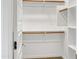 Walk-in closet with wooden hanging rods and shelves for ample storage at 9520 W Trumbull Rd, Tolleson, AZ 85353