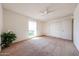 Bright bedroom with a ceiling fan, carpeted floor, and a window to let in natural light at 10326 W Pleasant Valley Rd, Sun City, AZ 85351