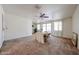 Bright living room featuring neutral walls, sliding glass door and a table with chairs at 10326 W Pleasant Valley Rd, Sun City, AZ 85351