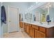 Bathroom featuring a large vanity, lots of mirrors and tile flooring at 10881 W Melinda Ln, Sun City, AZ 85373