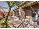 An outdoor covered patio featuring stone pillars, an outdoor dining set, and view of lush landscaping at 10883 E La Junta Rd, Scottsdale, AZ 85255