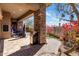 Beautiful outdoor living space featuring a stone pillar, built-in grill, and lush landscaping at 10883 E La Junta Rd, Scottsdale, AZ 85255