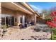 Inviting back patio with comfortable seating, stone pillar and colorful plants, perfect for outdoor relaxation at 10883 E La Junta Rd, Scottsdale, AZ 85255