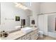 Well-lit bathroom featuring a vanity with granite countertops, vessel sink, and bathtub at 10883 E La Junta Rd, Scottsdale, AZ 85255