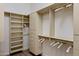 Organized walk-in closet featuring custom shelving, drawers, and ample hanging space at 10883 E La Junta Rd, Scottsdale, AZ 85255