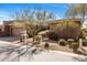 A well-maintained single-Gathering home featuring desert landscaping, a two-car garage, and a neutral stucco exterior at 10883 E La Junta Rd, Scottsdale, AZ 85255