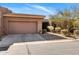 Charming home featuring a two-car garage and desert landscaping, creating appealing curb appeal at 10883 E La Junta Rd, Scottsdale, AZ 85255