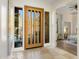 Inviting foyer showcasing a modern wood door, tile flooring, and bright natural light at 10883 E La Junta Rd, Scottsdale, AZ 85255