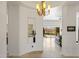 Elegant foyer featuring a decorative chandelier, wall niche, and open access to the living areas at 10883 E La Junta Rd, Scottsdale, AZ 85255