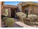 Inviting front entrance with stone accents and desert plants, welcoming guests with warmth and charm at 10883 E La Junta Rd, Scottsdale, AZ 85255