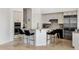 Stylish kitchen with a breakfast bar, stainless steel appliances, and mosaic tile backsplash at 10883 E La Junta Rd, Scottsdale, AZ 85255