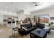 Bright and airy living room featuring a large sectional sofa, tile flooring, and seamless flow to the kitchen and dining areas at 10883 E La Junta Rd, Scottsdale, AZ 85255
