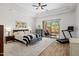 A spacious main bedroom with a king-size bed, walk-out to patio, and a ceiling fan at 10883 E La Junta Rd, Scottsdale, AZ 85255