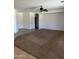 Open living space with neutral carpet leading to tiled entryway and white painted walls at 11064 E Reginald Ave, Mesa, AZ 85212