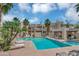 Community pool surrounded by palm trees, lounge chairs, and the apartment complex at 11333 N 92Nd St # 2028, Scottsdale, AZ 85260