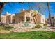 Community sign for Mission de los Arroyos, surrounded by green grass and desert landscaping at 11333 N 92Nd St # 2028, Scottsdale, AZ 85260