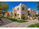 Beige complex featuring desert landscaping, sidewalks and building with reserved parking and green landscaping at 11333 N 92Nd St # 2028, Scottsdale, AZ 85260