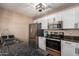 Bright kitchen featuring stainless steel appliances, granite countertops, and white cabinets at 11333 N 92Nd St # 2028, Scottsdale, AZ 85260