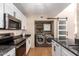 Modern kitchen with granite countertops, stainless steel appliances, white cabinets, and laundry area at 11333 N 92Nd St # 2028, Scottsdale, AZ 85260