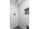 This contemporary shower boasts sleek white tiling, a stylish mosaic inlay, and modern fixtures at 11333 N 92Nd St # 2028, Scottsdale, AZ 85260