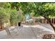 Serene backyard featuring mature trees, an orange tree, manicured landscaping and a seating area at 1134 E Magdalena Dr, Tempe, AZ 85283