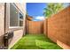 Backyard features artificial turf and block fencing offering privacy at 1214 N 84Th Pl, Scottsdale, AZ 85257