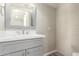 Updated bathroom featuring a gray vanity, modern sink, and tiled shower/tub combination at 1214 N 84Th Pl, Scottsdale, AZ 85257