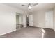 Neutral bedroom with large mirrored closet doors, ceiling fan and gray carpet at 1214 N 84Th Pl, Scottsdale, AZ 85257