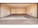 A peek inside this unfinished garage and it's cement flooring with a door to the home at 1214 N 84Th Pl, Scottsdale, AZ 85257