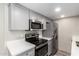 Updated kitchen with gray cabinets, modern appliances, and quartz countertops at 1214 N 84Th Pl, Scottsdale, AZ 85257