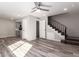 Open-concept living room with wood floors, staircase, and access to the kitchen at 1214 N 84Th Pl, Scottsdale, AZ 85257