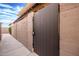 Gated side yard features block wall with walkway, desert landscaping, and address marker at 1214 N 84Th Pl, Scottsdale, AZ 85257