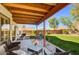 Spacious backyard featuring a covered patio with outdoor seating and a well-maintained lawn at 1314 E Bluefield Ave, Phoenix, AZ 85022