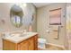 Bathroom with a vanity and cabinets, a decorative mirror, and a shower/tub combination at 1314 E Bluefield Ave, Phoenix, AZ 85022