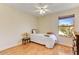 Minimalist bedroom with a simple bed, wood floors, and a bright window at 1314 E Bluefield Ave, Phoenix, AZ 85022