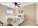 Cozy bedroom with a colorful floral bedspread, window, and ceiling fan at 1314 E Bluefield Ave, Phoenix, AZ 85022