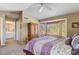 Comfortable bedroom with a light purple bedspread, ceiling fan and large window at 1314 E Bluefield Ave, Phoenix, AZ 85022