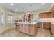 Contemporary kitchen with a central island, stainless steel appliances, and light wood cabinetry at 1314 E Bluefield Ave, Phoenix, AZ 85022